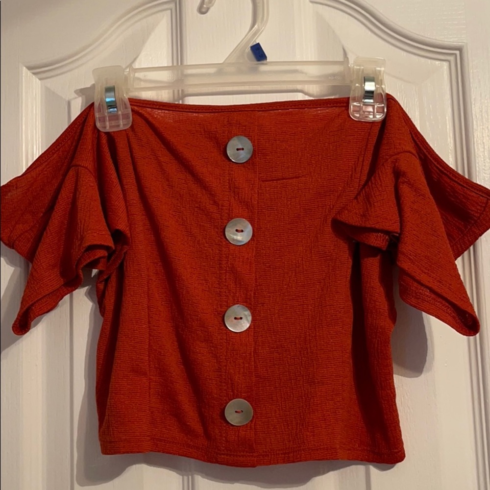 Red-orange blouse off the shoulder